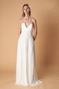 Ceylan Bcn Monaco long dress in flowing fabric with elegant design, detailed neckline, and full-length silhouette.