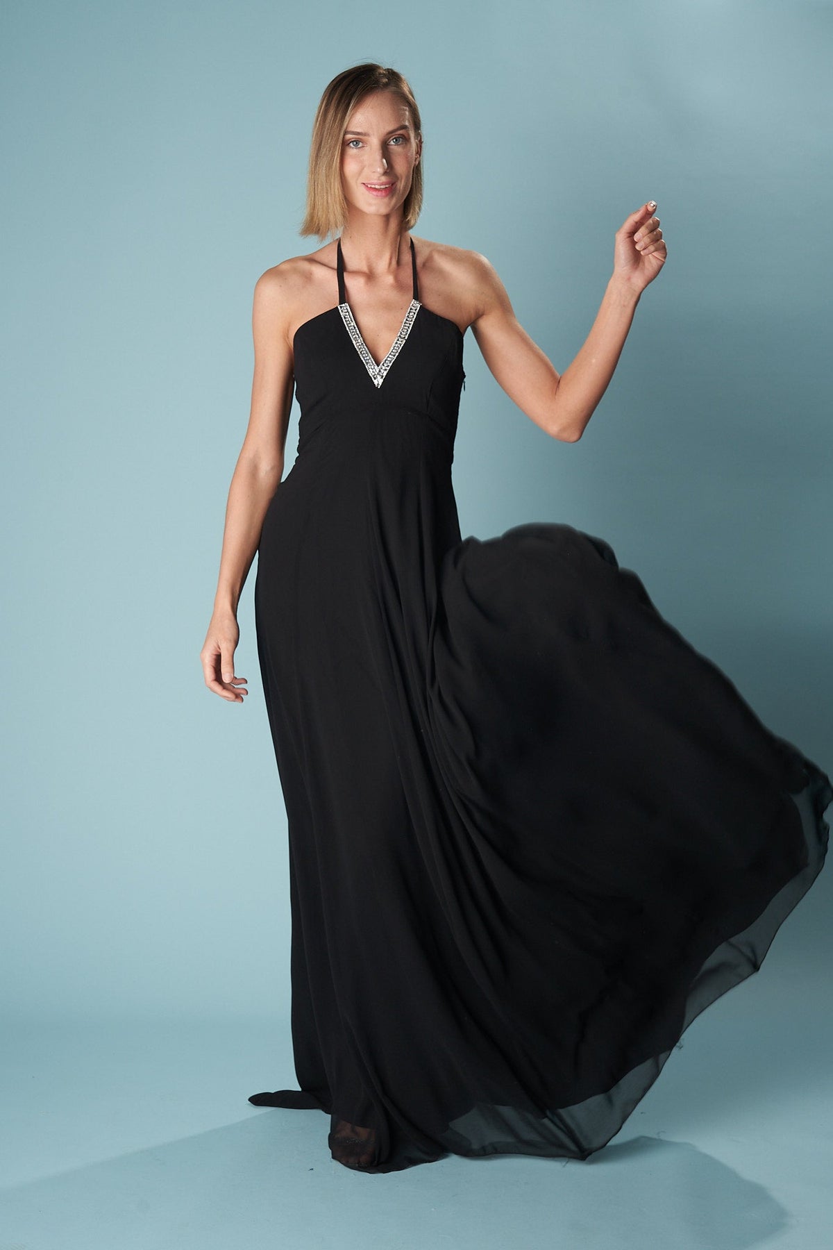 Ceylan Bcn Monaco long dress in flowing fabric with elegant design, shown on a hanger against a neutral background.