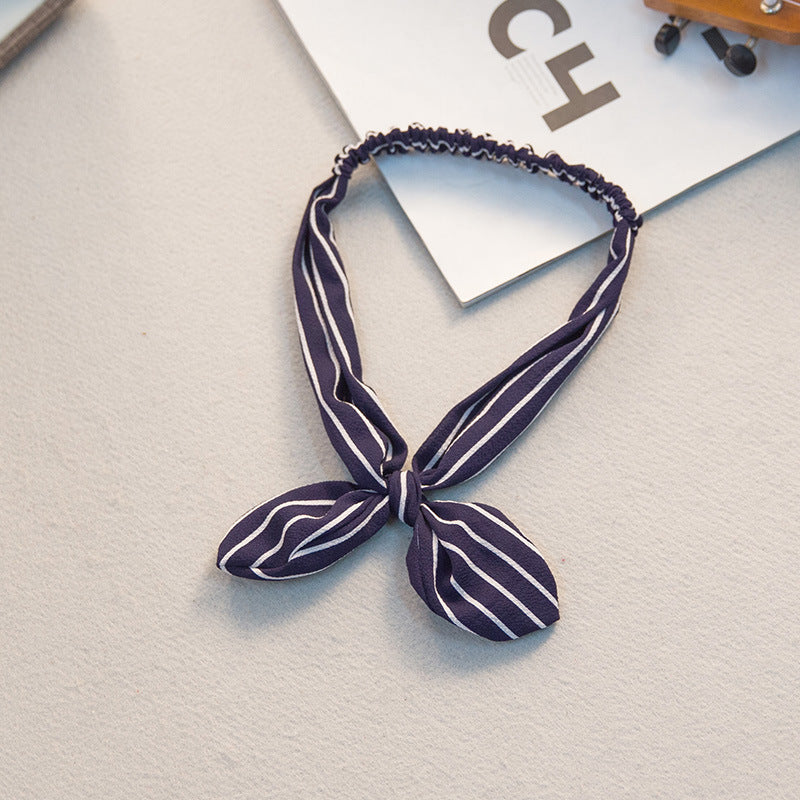 Big bow tie bunny ears headband in a playful design