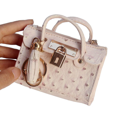 Leather solid color fashion tassel mini handbag with compact design and decorative tassel detail