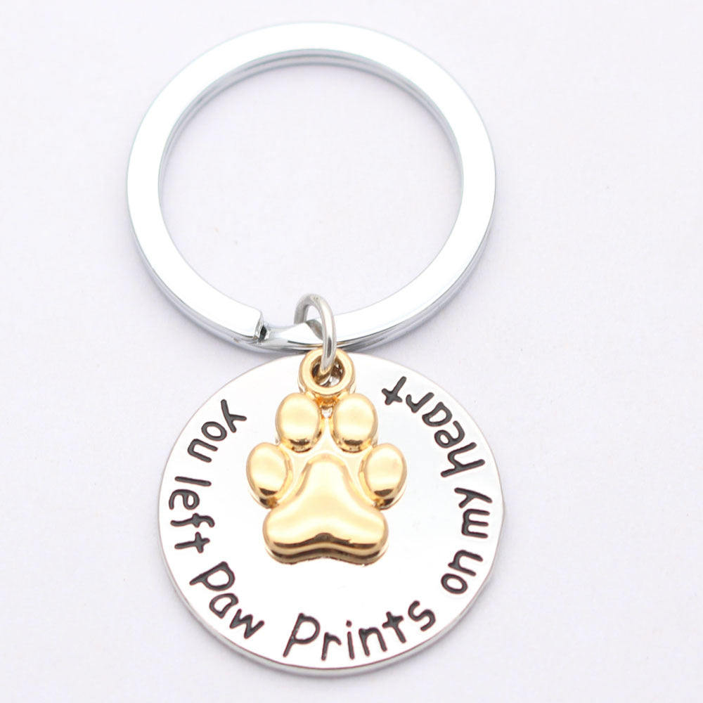 Dog paw necklace pendant on a delicate chain, close-up product view