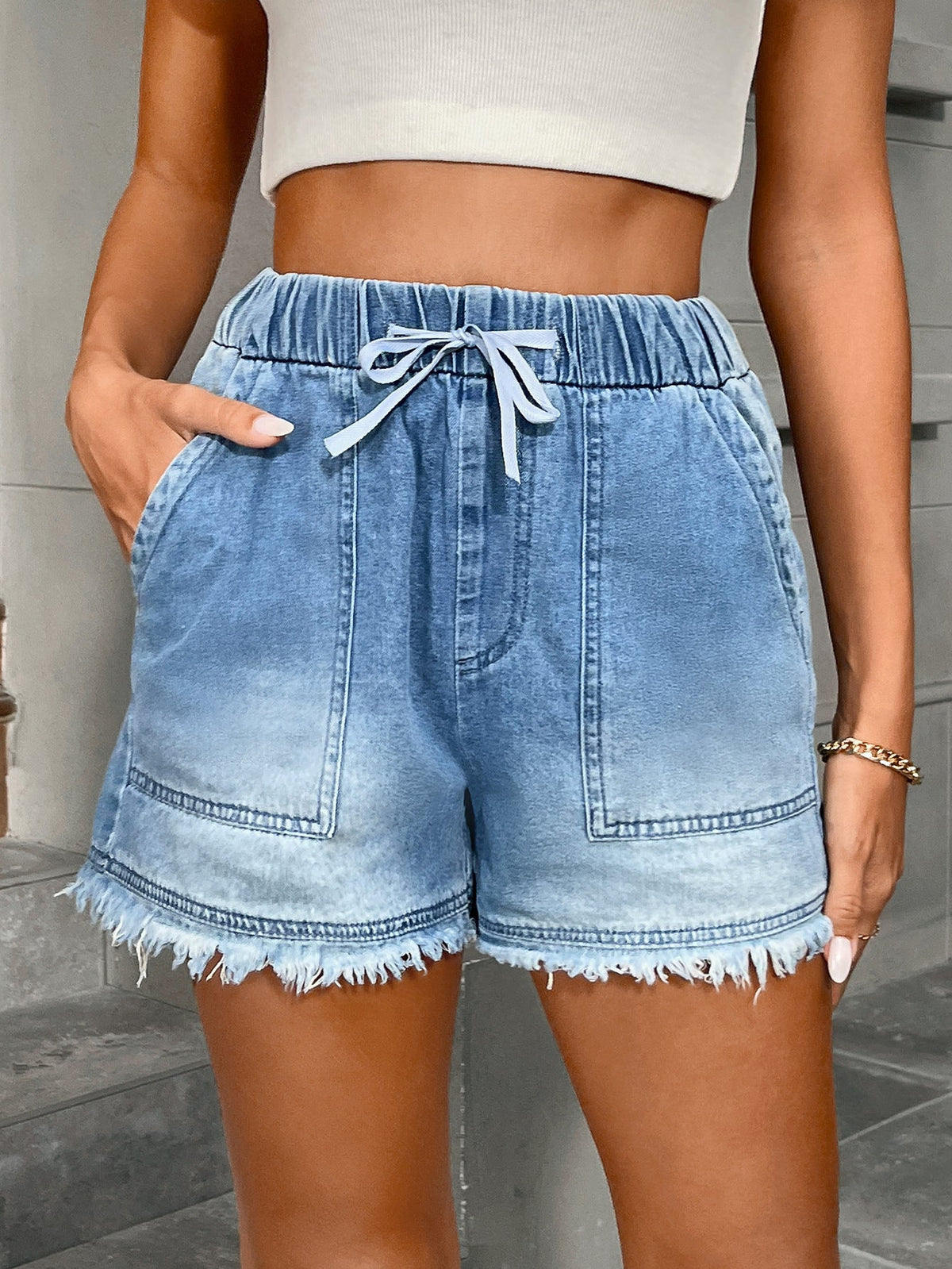 Women’s denim shorts with elastic waist and drawstring waistband, blue casual design