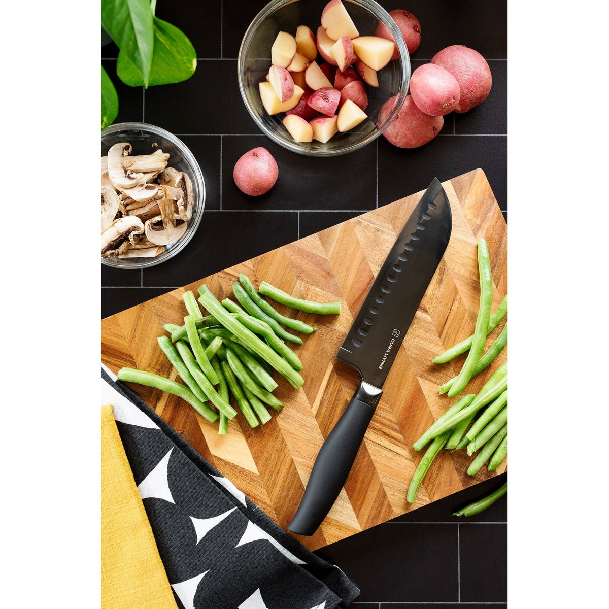 Dura Living Titan 7-inch black Santoku knife with a sharp stainless steel blade and ergonomic handle for precise slicing.