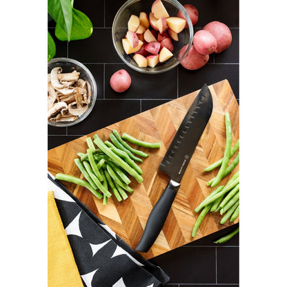 Dura Living Titan 7-inch black Santoku knife with a sharp stainless steel blade and ergonomic handle for precise slicing.