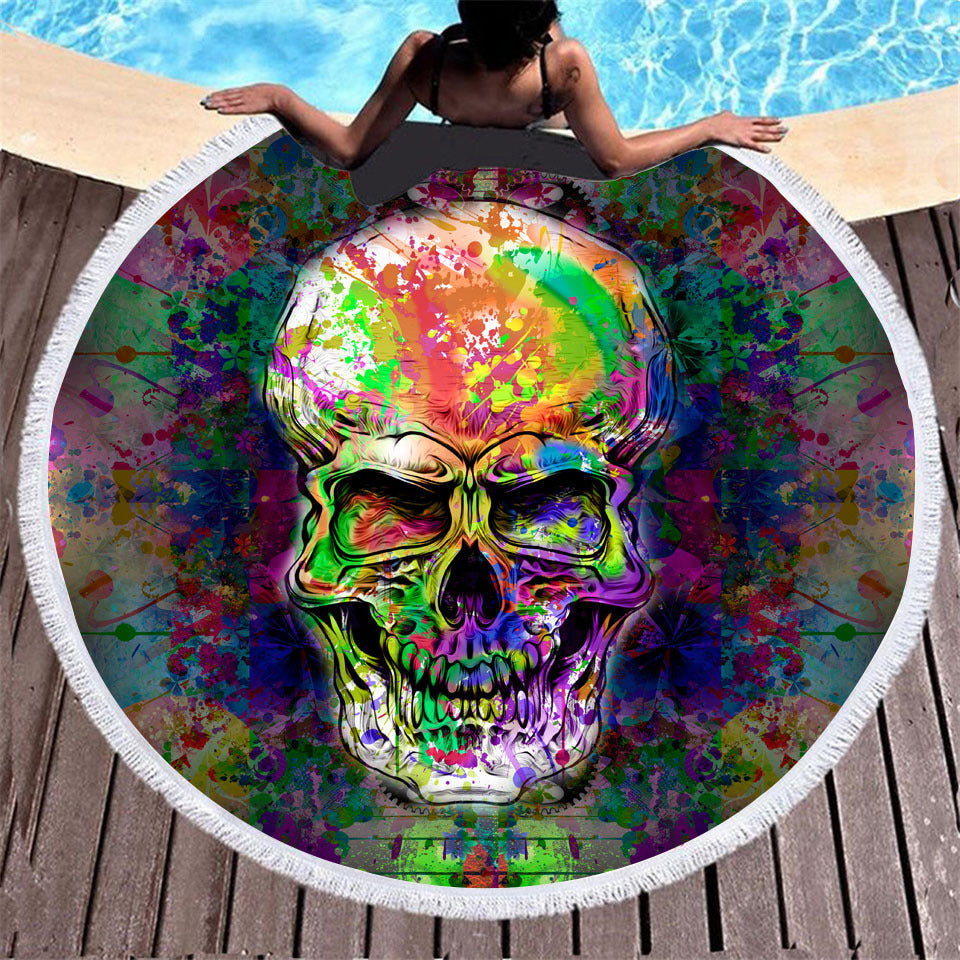 Skull print round beach towel with tassel trim, folded to show the detailed design