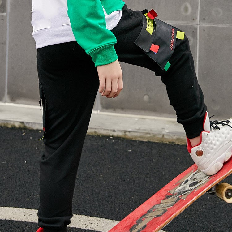 New knitted boy pants in soft fabric, front view, neutral color with elastic waistband and cuffed legs