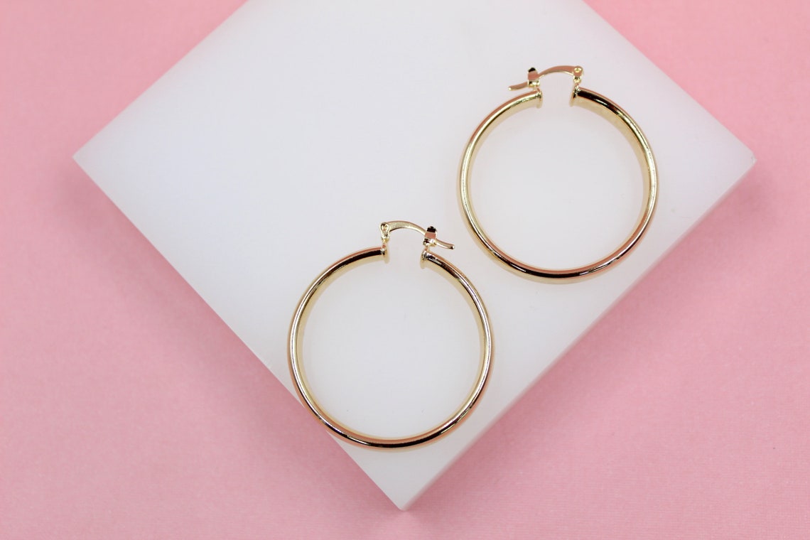 18K gold-filled 6mm thin lever back hoop earrings by MIA Jewelry, showcasing sleek and elegant gold hoops.