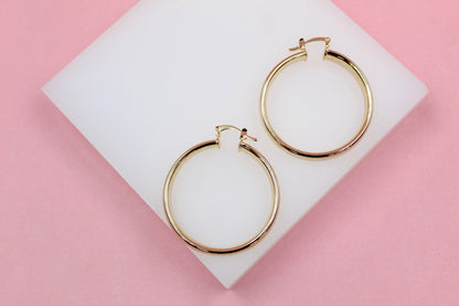 18K gold-filled 6mm thin lever back hoop earrings by MIA Jewelry, showcasing sleek and elegant gold hoops.