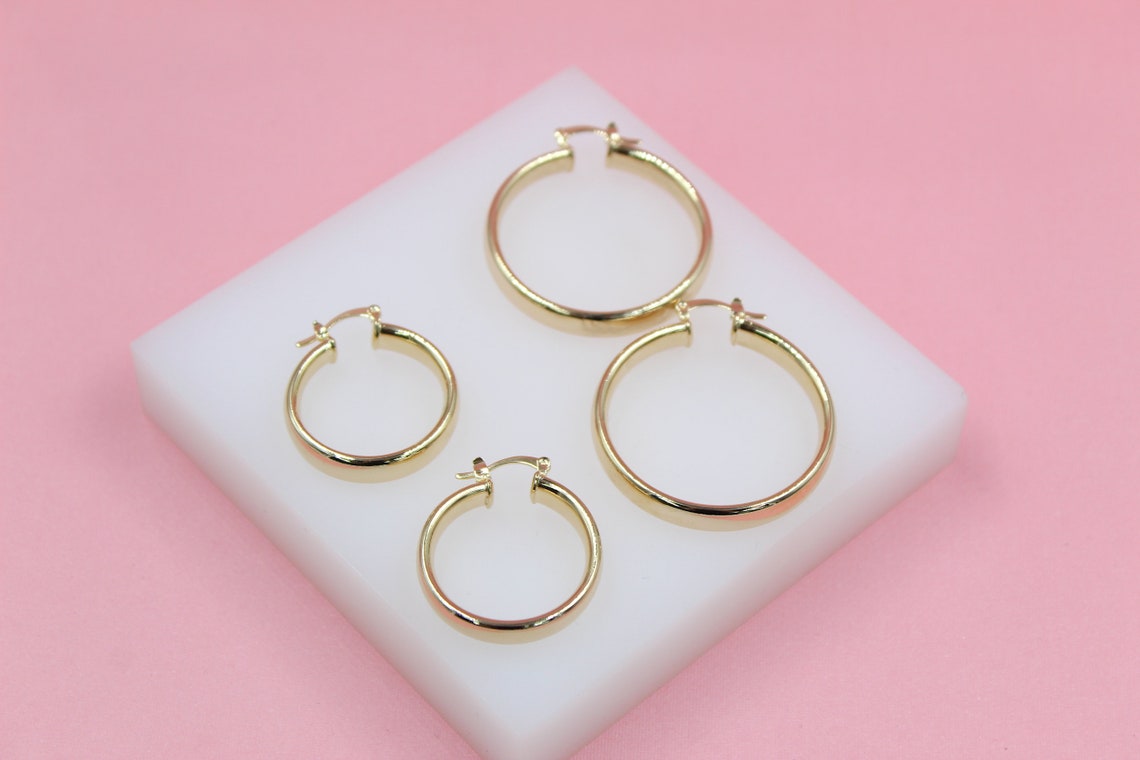 MIA Jewelry 18K gold filled 6mm thin lever back hoop earrings, showcasing sleek, shiny gold hoops on a white background.