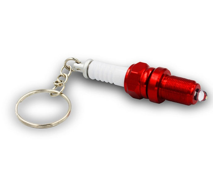 LED light spark plug keychain with compact metallic design and attached key ring