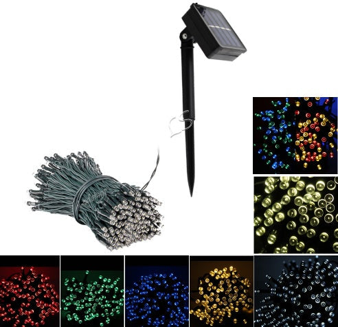 Christmas garden LED solar string lights with decorative bulbs on green foliage