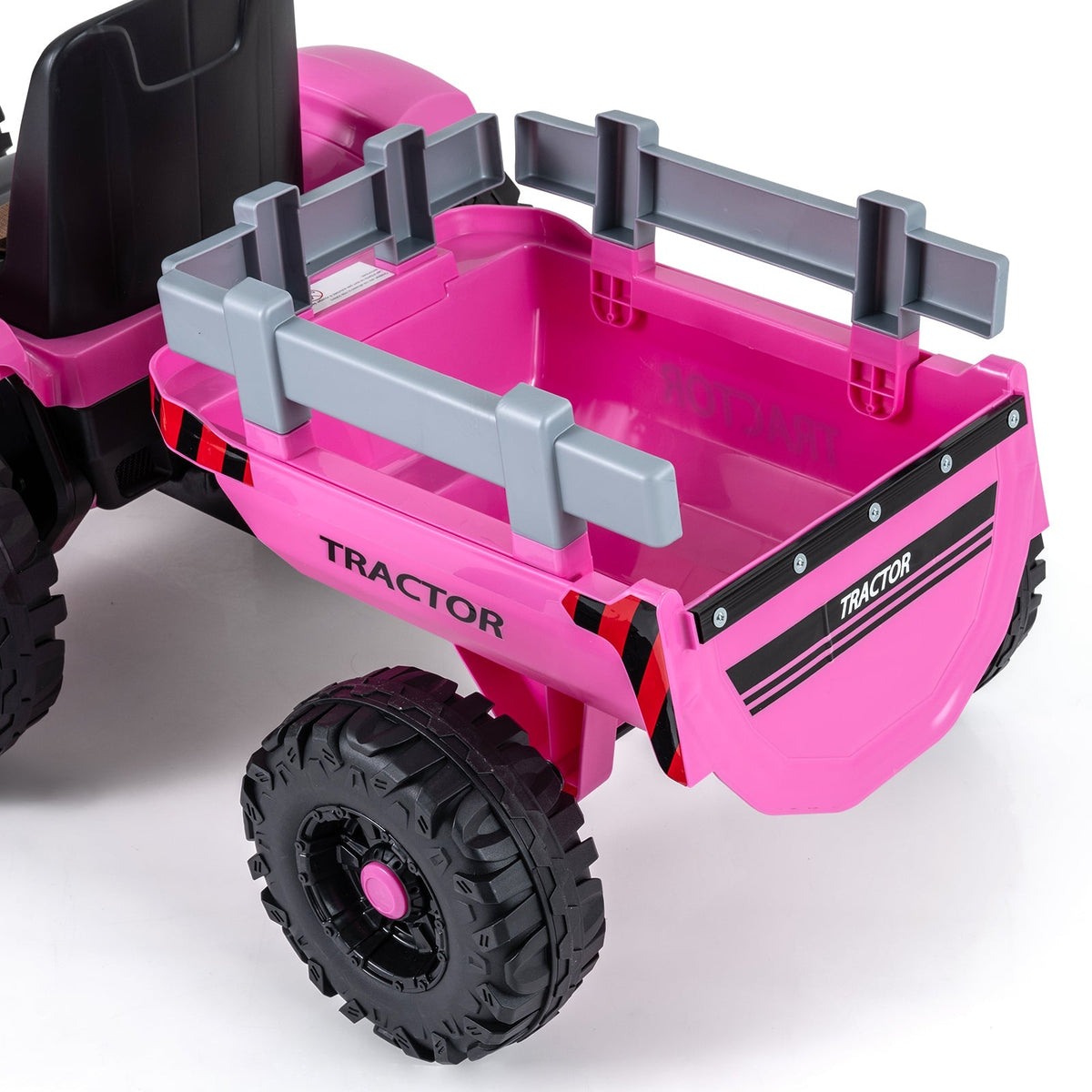 Kids riding a 24V electric tractor with a detachable trailer and remote control for easy supervision.