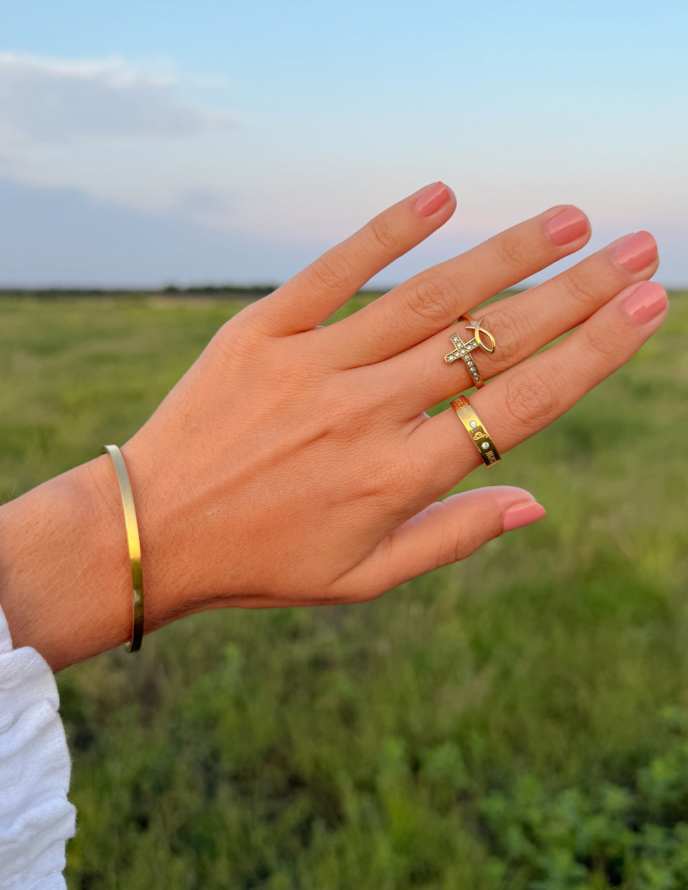 Elevated Faith gemstone logo ring featuring a polished band with a central gemstone and engraved logo design.