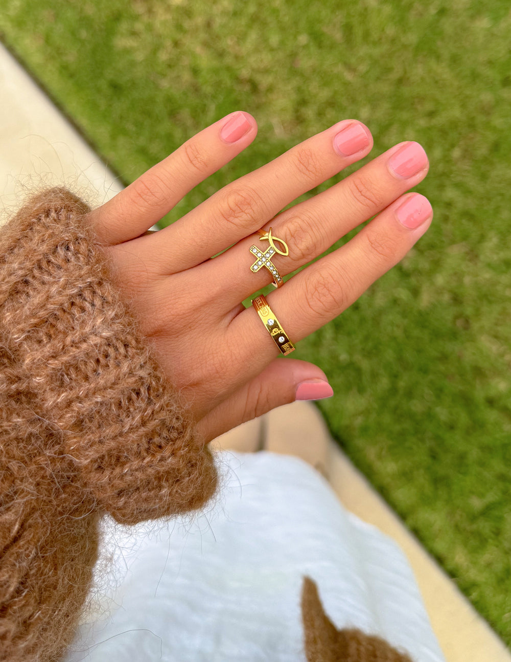 Elevated Faith gemstone logo ring with colorful stones and polished silver band, showcasing a sleek and stylish jewelry design.
