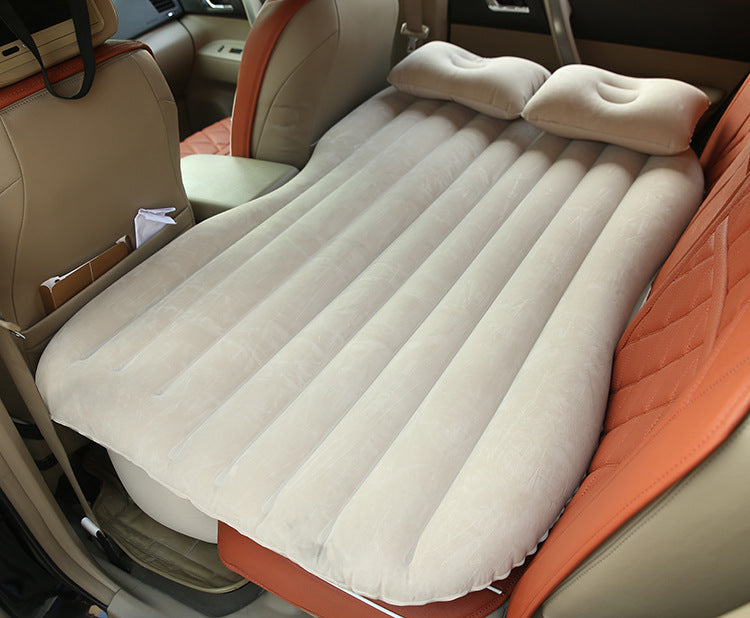 Inflatable car bed with cushioned surface, designed for comfortable sleeping and travel in vehicles