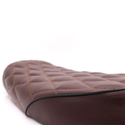 Retro modified diamond cushion for motorcycle seat, black textured upholstery close-up