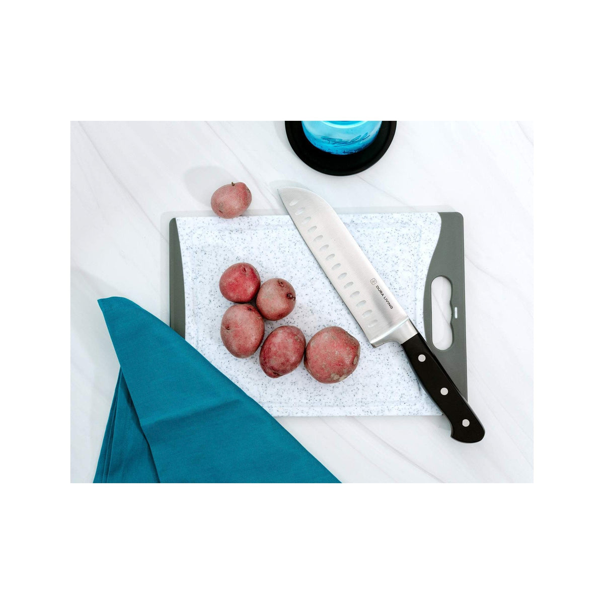 Dura Living Superior 4-piece black kitchen knife set with stainless steel blades and ergonomic handles, displayed on a wooden surface.