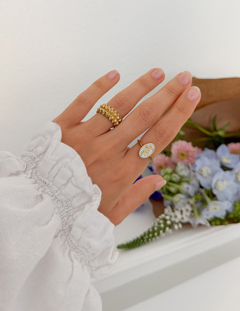 Elevated Faith Bloom Again enamel ring with floral design, silver band, and colorful enamel accents on a white background.