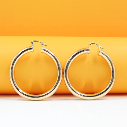 18K gold-filled thick lever back hoop earrings by MIA Jewelry, featuring open gold hoop studs.