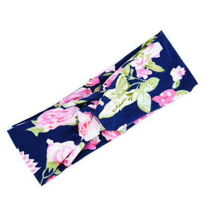 Floral cross hair band with decorative flower details, shown in a close-up product view