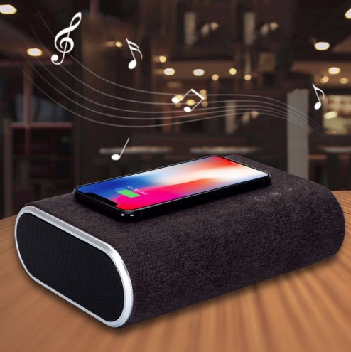 Wireless charger speaker with compact design and integrated charging pad