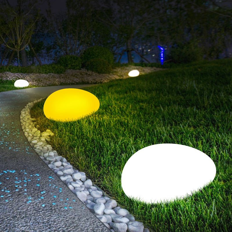 Solar light stone LED grass lamp with textured stone design and integrated LED light for outdoor ground lighting