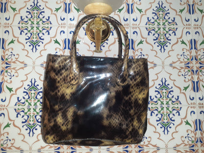 Handmade women's handbag with sturdy handles, crafted for stylish carrying and everyday use.