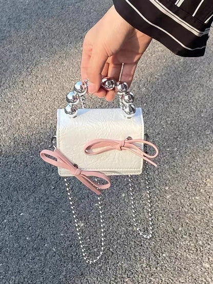 Textured cute bow mini chain handbag with compact design and decorative bow detail