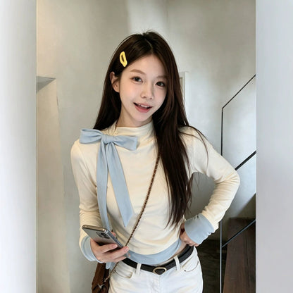 Light blue women’s long-sleeved blouse with a bow detail