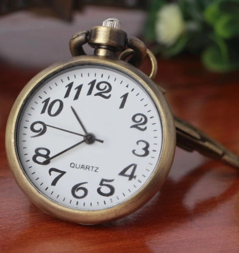 Vintage pocket watch with classic round case and visible clock face ต่ํา