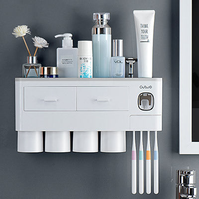 Non-marking hanging magnetic toothbrush holder with single drawer, toothpaste squeezer, and toiletry storage rack
