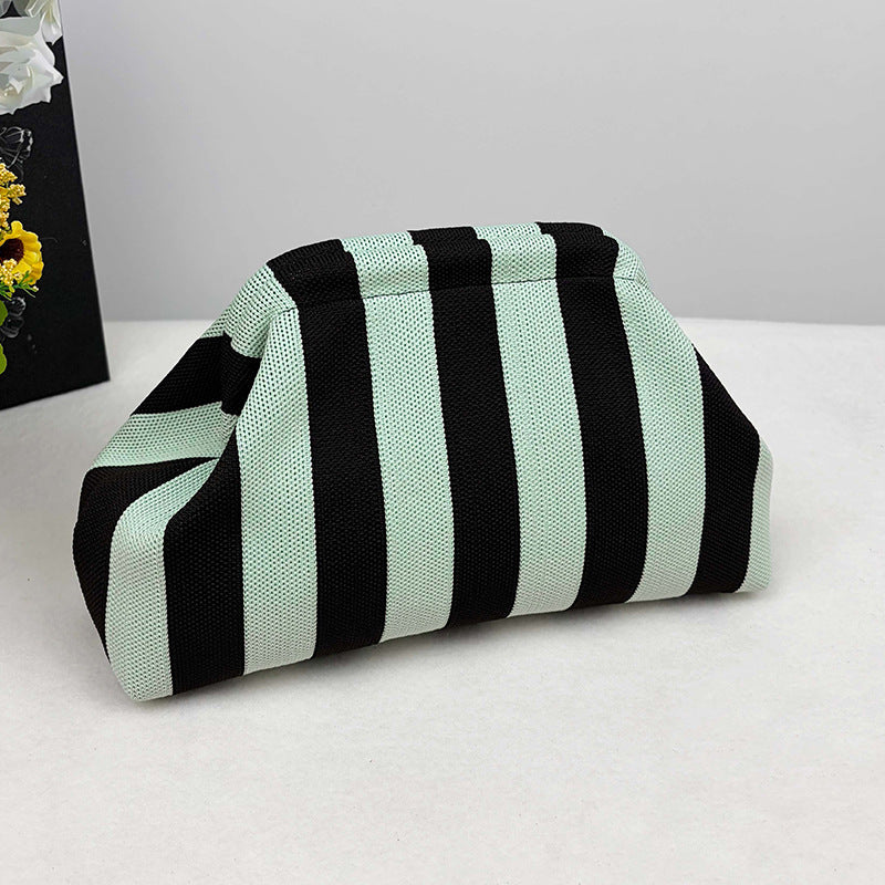 Women's knitted striped clutch bag folded in a compact rectangular shape