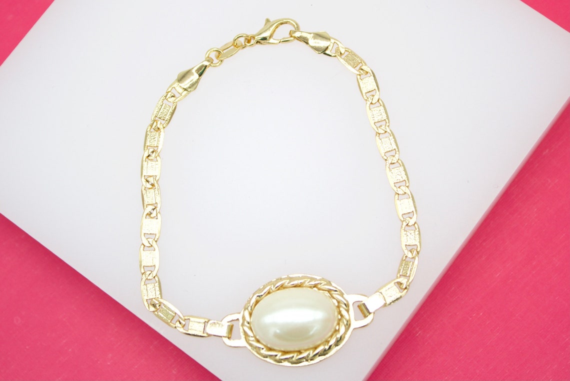 18K gold filled synthetic pearl bracelet by MIA Jewelry featuring elegant design and lustrous pearls on a delicate chain.