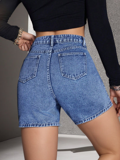 Distressed vintage non-stretch denim shorts in classic blue wash with frayed hems