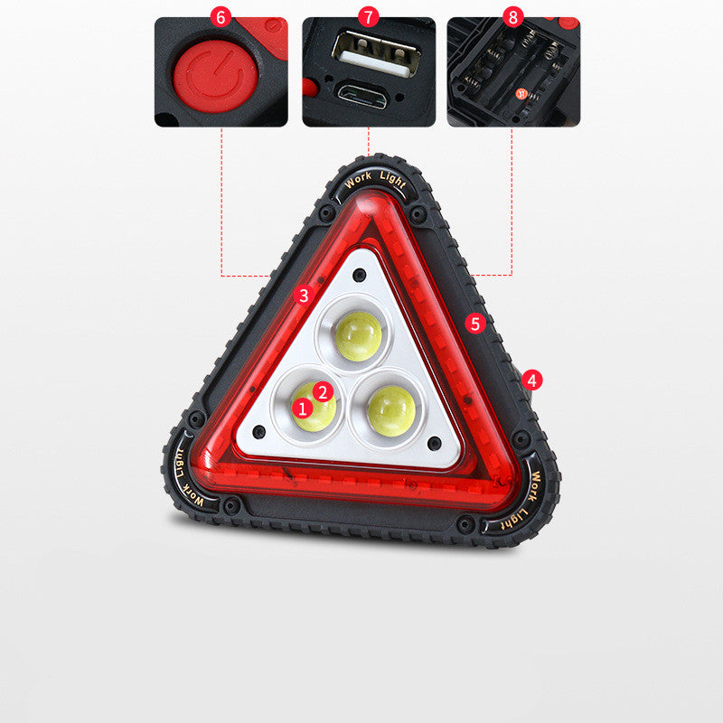 Triangular red warning light viewed from the front, featuring a bold red housing and visible warning symbol
