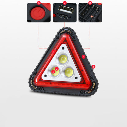 Triangular red warning light viewed from the front, featuring a bold red housing and visible warning symbol