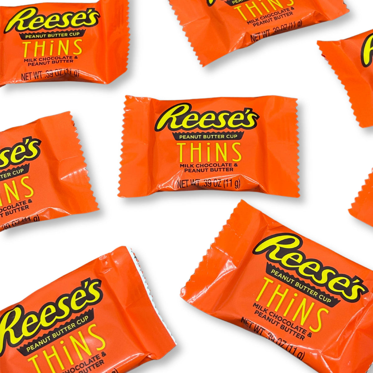 Two Reese's Peanut Butter Cup Thins Milk Chocolate candies from Candy In Bulk, showing smooth milk chocolate coating and peanut butter filling