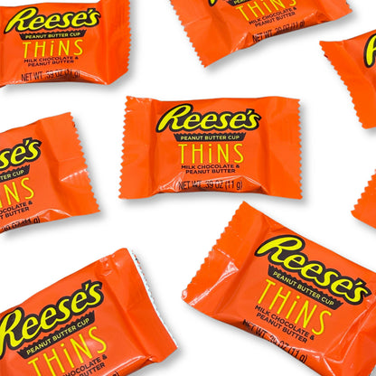 Two Reese's Peanut Butter Cup Thins Milk Chocolate candies from Candy In Bulk, showing smooth milk chocolate coating and peanut butter filling