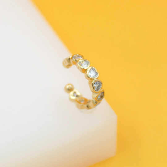 Gold filled CZ heart-shaped ear cuff earrings by MIA Jewelry, showcasing a sparkling heart design on a sleek gold cuff.