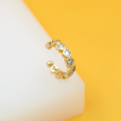 Gold filled CZ heart-shaped ear cuff earrings by MIA Jewelry, showcasing a sparkling heart design on a sleek gold cuff.