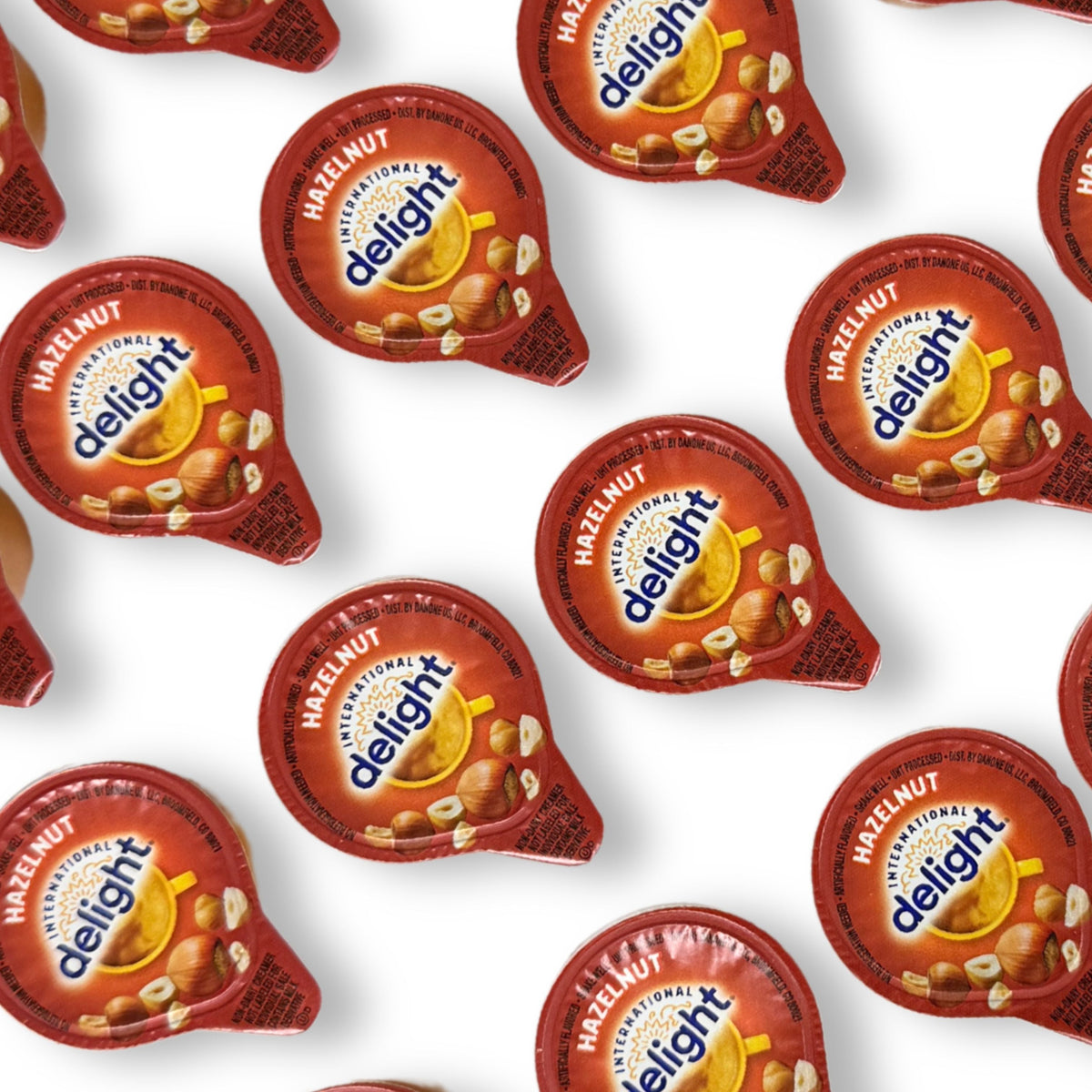 International Delight Hazelnut Coffee Creamer single-serve cup with branding, creamy texture, and label details visible.