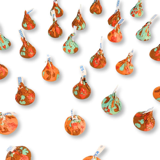 Two Hershey's Kisses Milk Chocolate candies wrapped in fall-themed foils from Candy In Bulk, displayed on a white background.