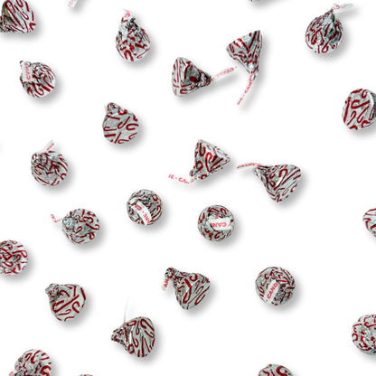 Hershey’s Kisses Candy Cane Mint chocolates with red and white stripes and candy bits in a bulk bag, from Candy In Bulk.