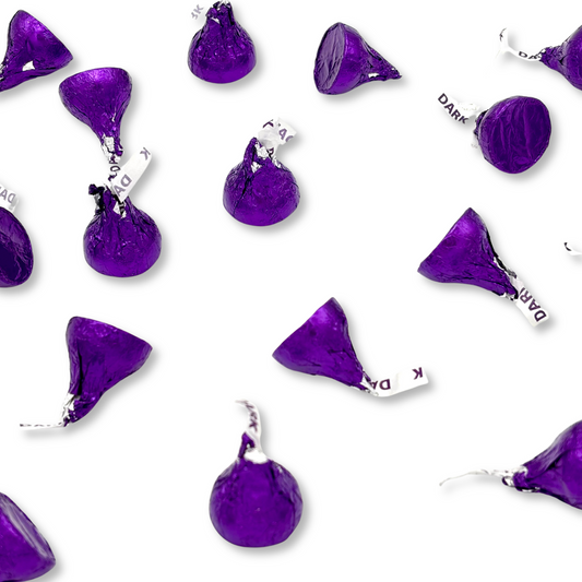 Two Hershey's Kisses Special Dark Mildly Sweet Chocolate candies from Candy In Bulk's bulk value bag, showing the foil-wrapped chocolates.