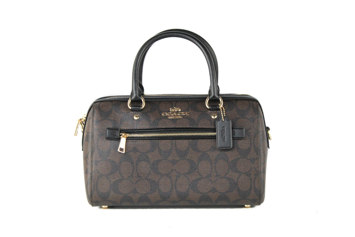 Brown and black Coach Rowan medium satchel handbag with signature leather design, featuring top handles and a classic purse style.