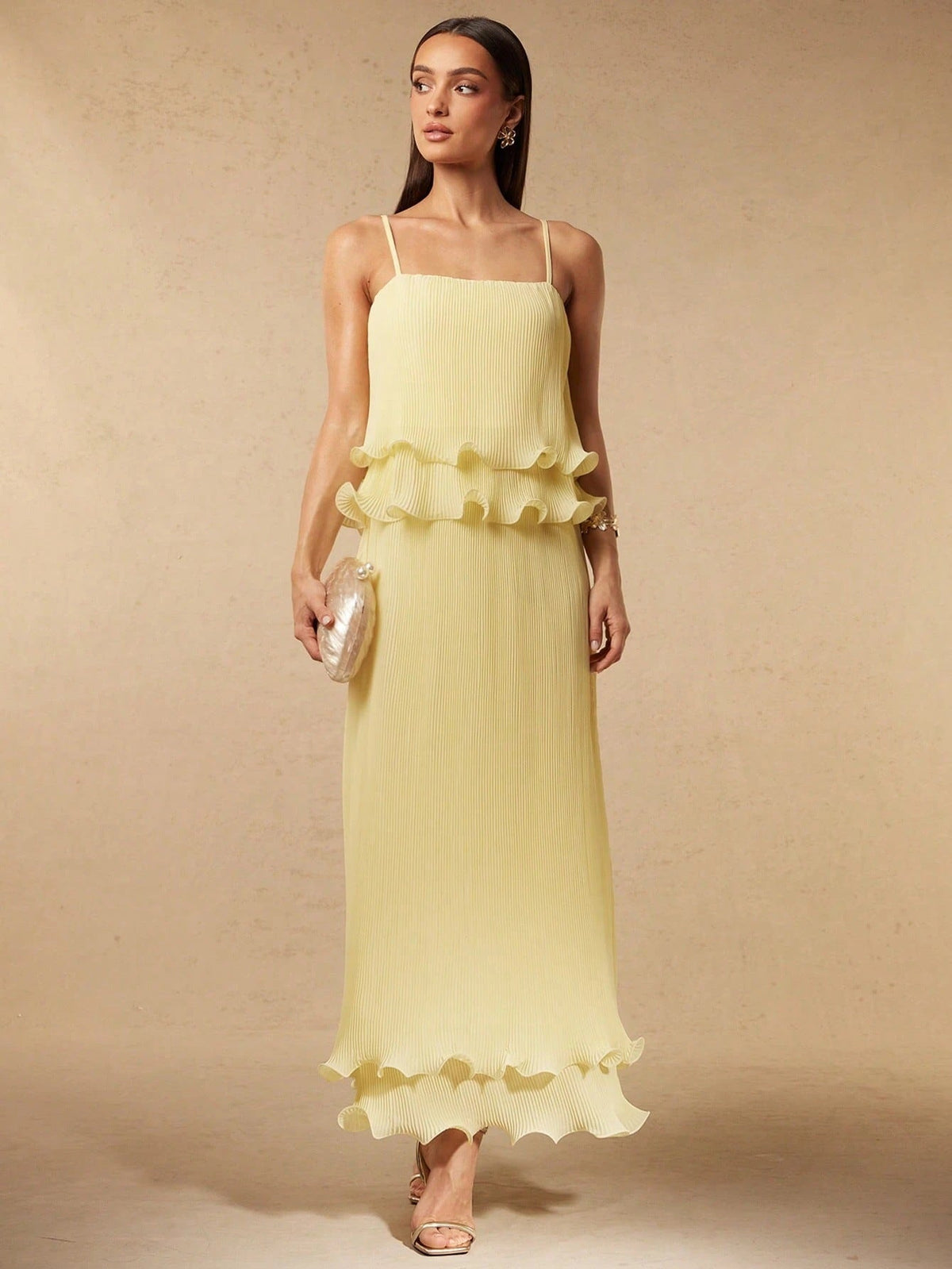 Pleated yellow strap spliced tiered long dress with flowing silhouette and sleeveless design