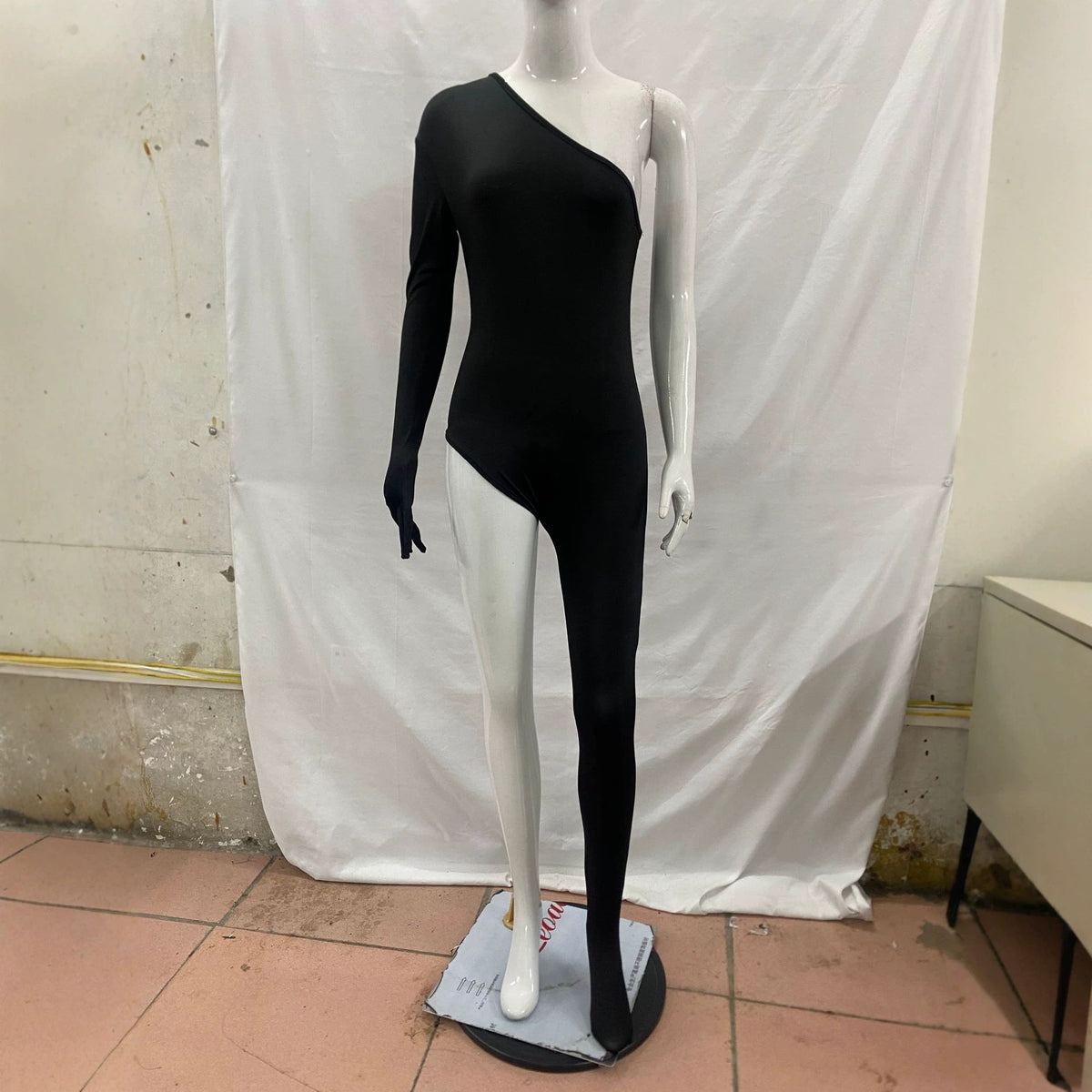 One-shoulder jumpsuit with slimming leg-revealing design, shown from the front