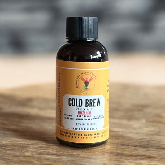 2oz Rising For People Coffee Co. Cold Brew Concentrate in a small travel-sized bottle, ideal for on-the-go coffee brewing.
