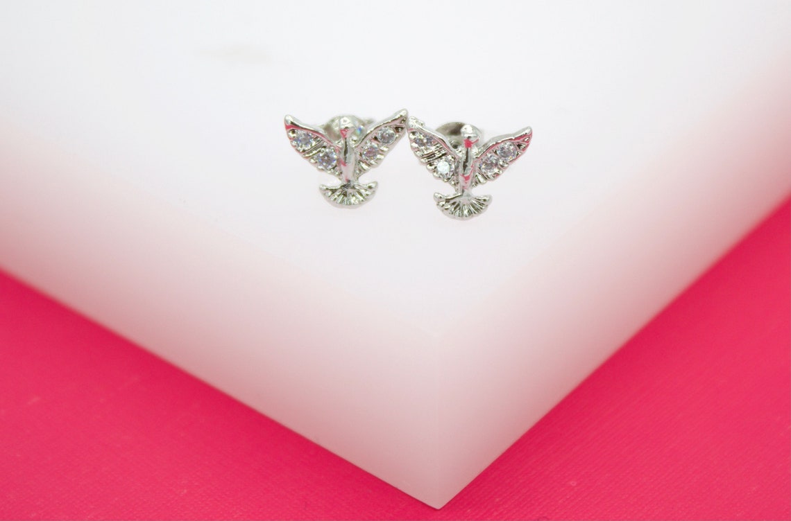 18K gold filled dove stud earrings by MIA Jewelry with cubic zirconia stones, featuring a delicate bird design and sparkling accents.