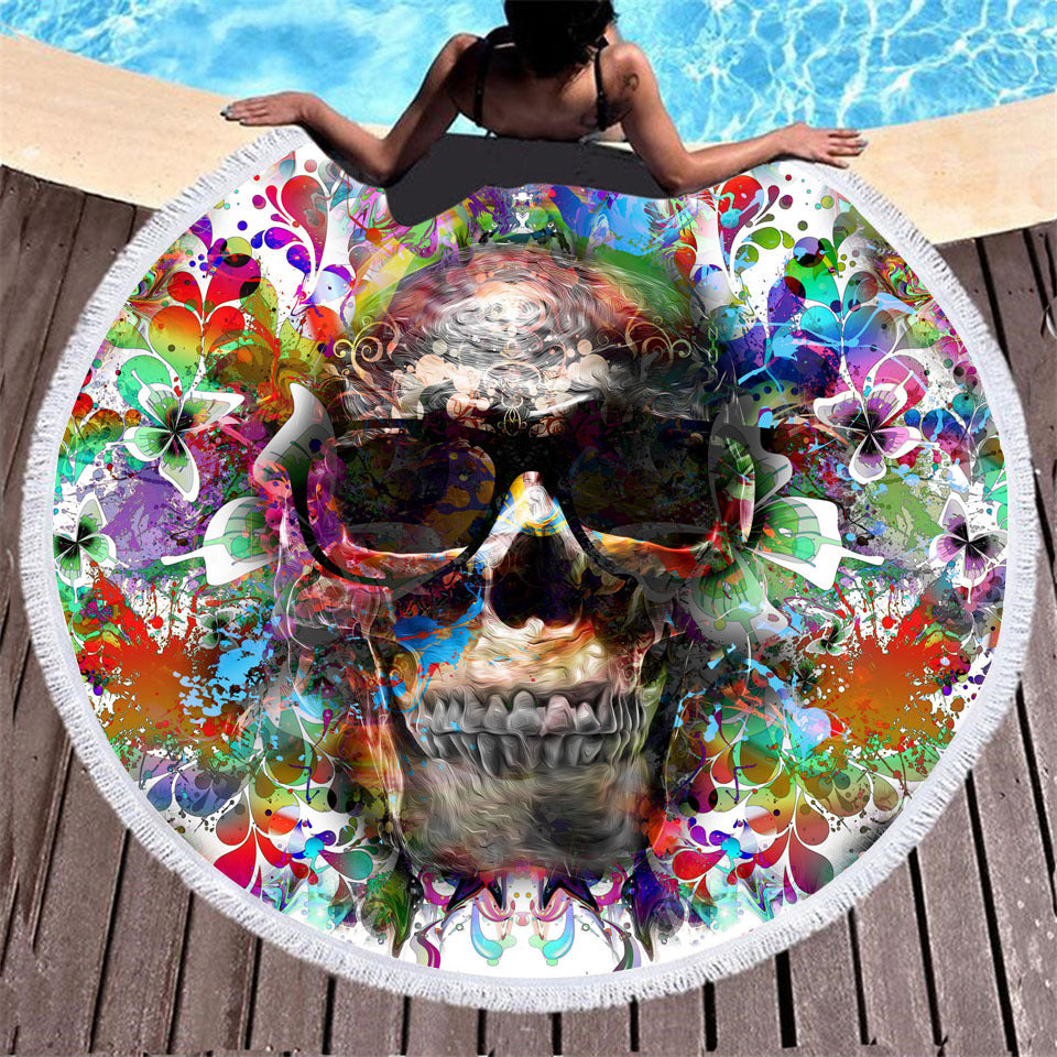 Skull print round beach towel with decorative tassel trim, displayed flat